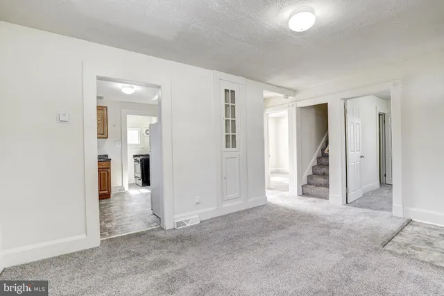 an empty room with windows and bathroom view