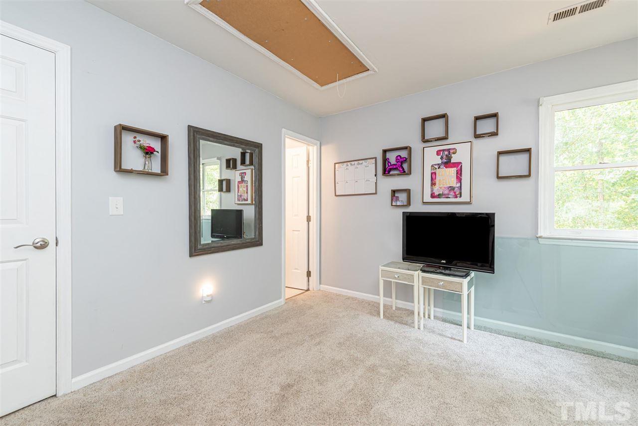 3508 Singleleaf Lane Raleigh, NC 27616 - Photo 15 of 20 a workspace with a flat screen tv and a window