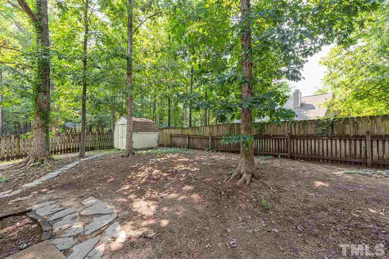 3508 Singleleaf Lane Raleigh, NC 27616 - Photo 18 of 20 a view of a fence with trees in the background