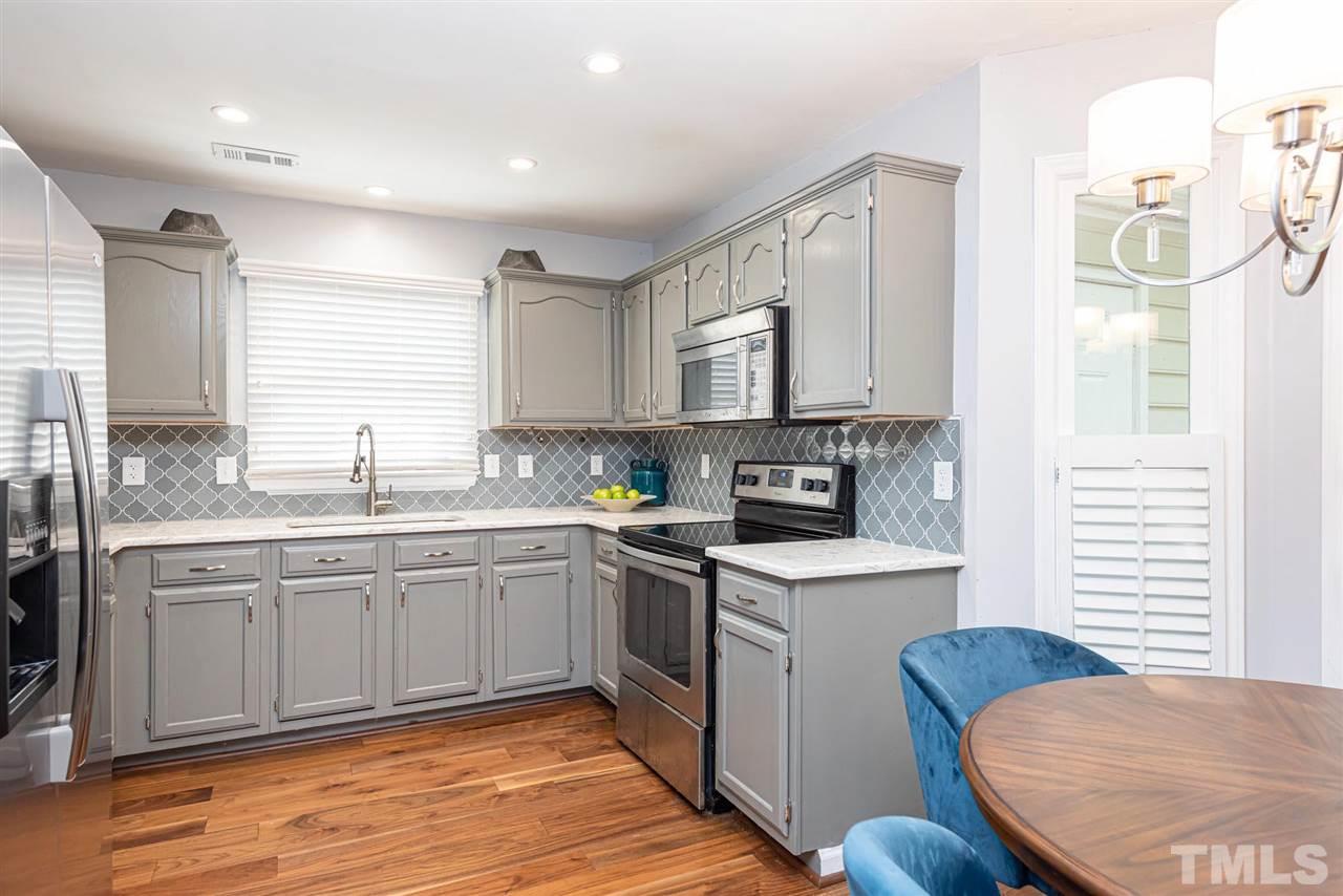 3508 Singleleaf Lane Raleigh, NC 27616 - Photo 7 of 20 a kitchen with stainless steel appliances granite countertop a stove a sink and a refrigerator