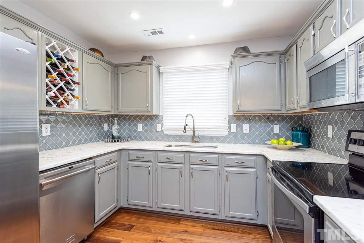 3508 Singleleaf Lane Raleigh, NC 27616 - Photo 8 of 20 a kitchen with a sink cabinets and window