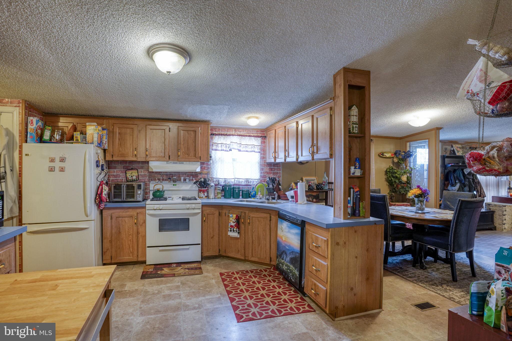 15450 Weigela Drive Georgetown, DE 19947 - Photo 26 of 37 Cozy kitchen with warm wood accents.
