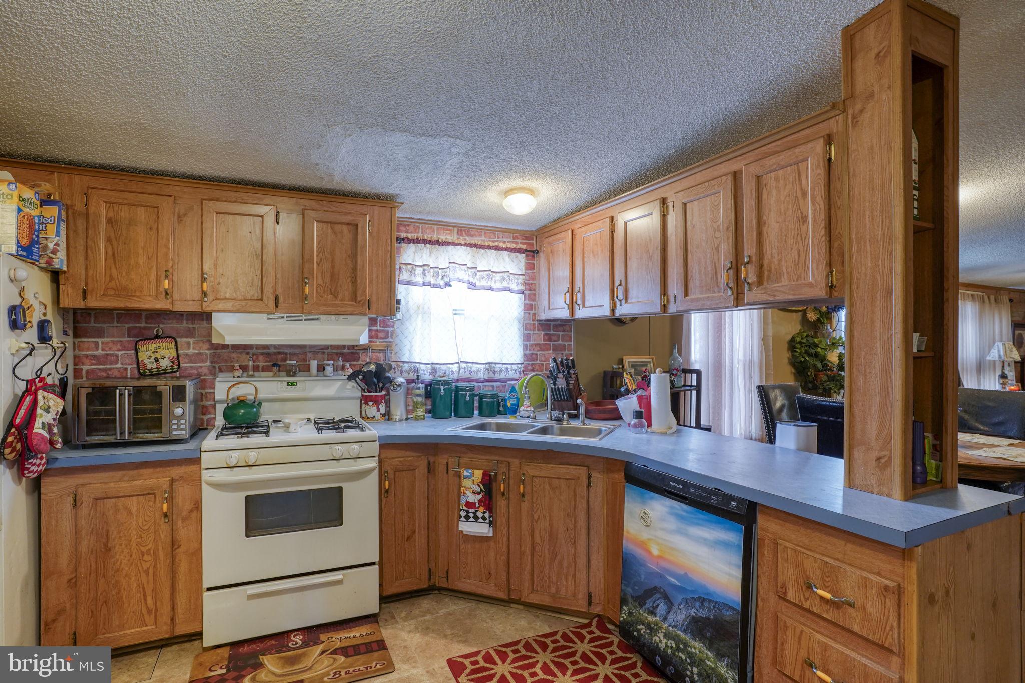 15450 Weigela Drive Georgetown, DE 19947 - Photo 27 of 37 Cozy kitchen with rustic charm.