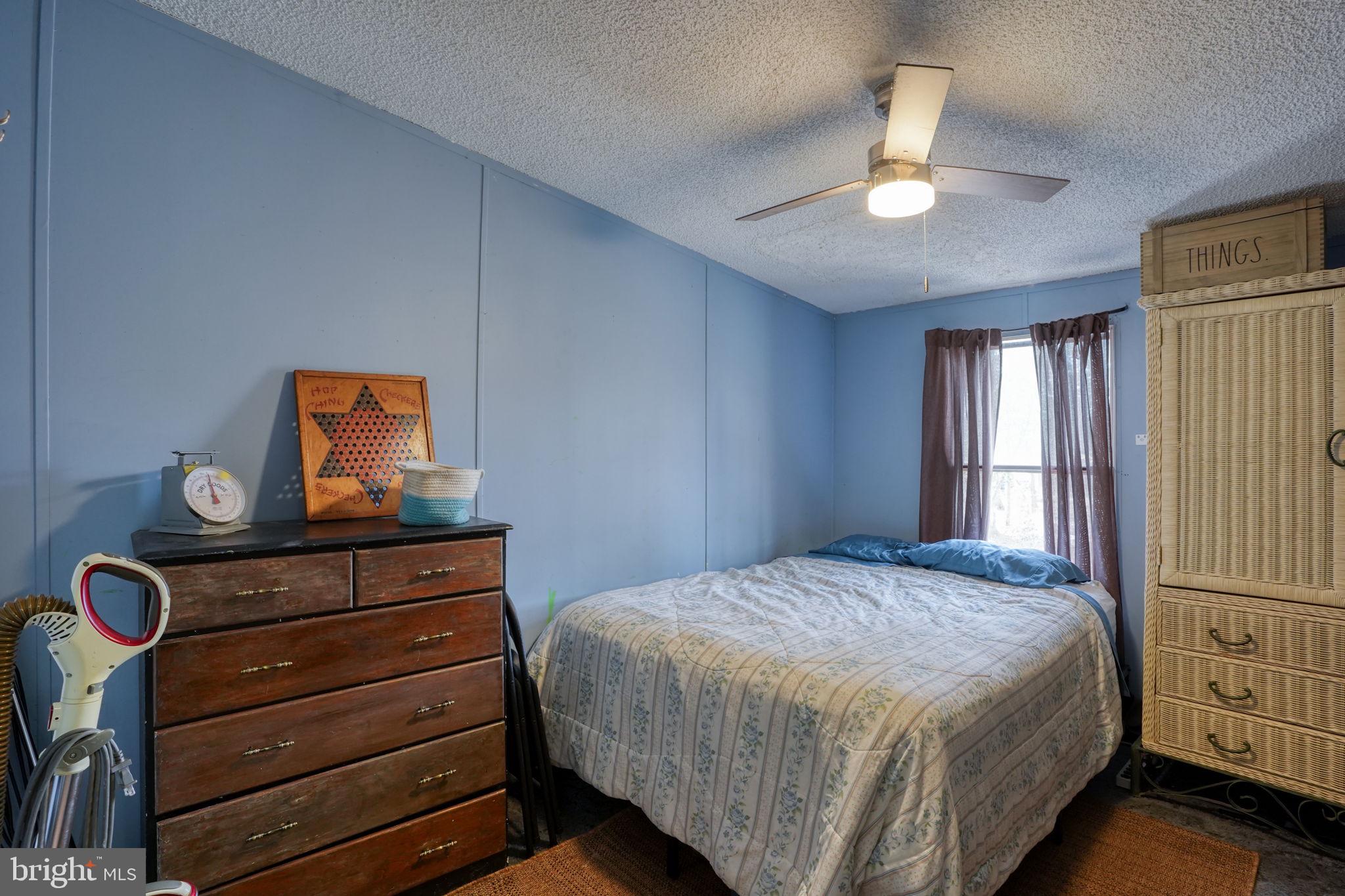 15450 Weigela Drive Georgetown, DE 19947 - Photo 29 of 37 Cozy bedroom with calming blue hues.