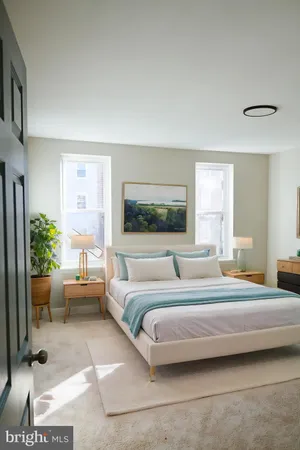 a bedroom with a large bed and a couch