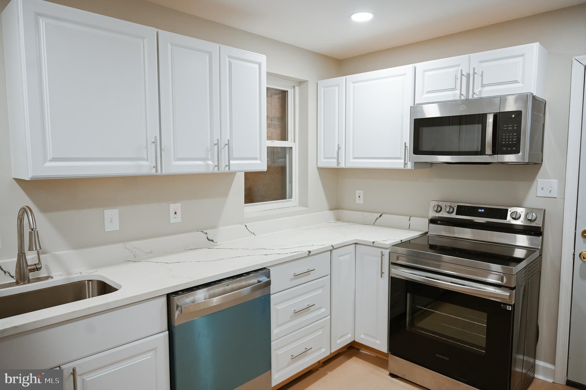 2214 East Fayette Street Baltimore, MD 21231 - Photo 12 of 40 a kitchen with stainless steel appliances granite countertop grey cabinets a stove a sink and dishwasher