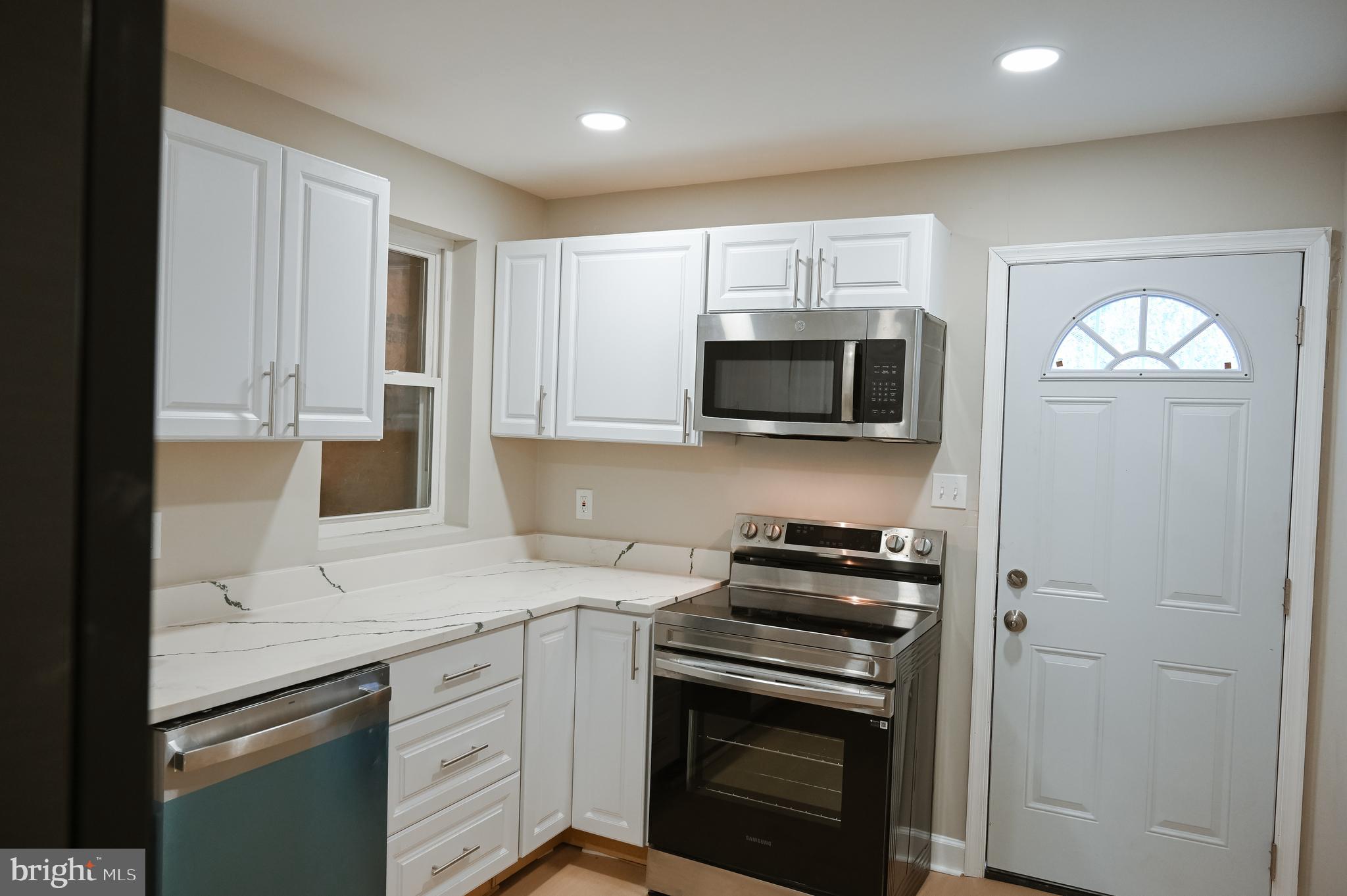 2214 East Fayette Street Baltimore, MD 21231 - Photo 13 of 40 a kitchen with appliances a sink and cabinets
