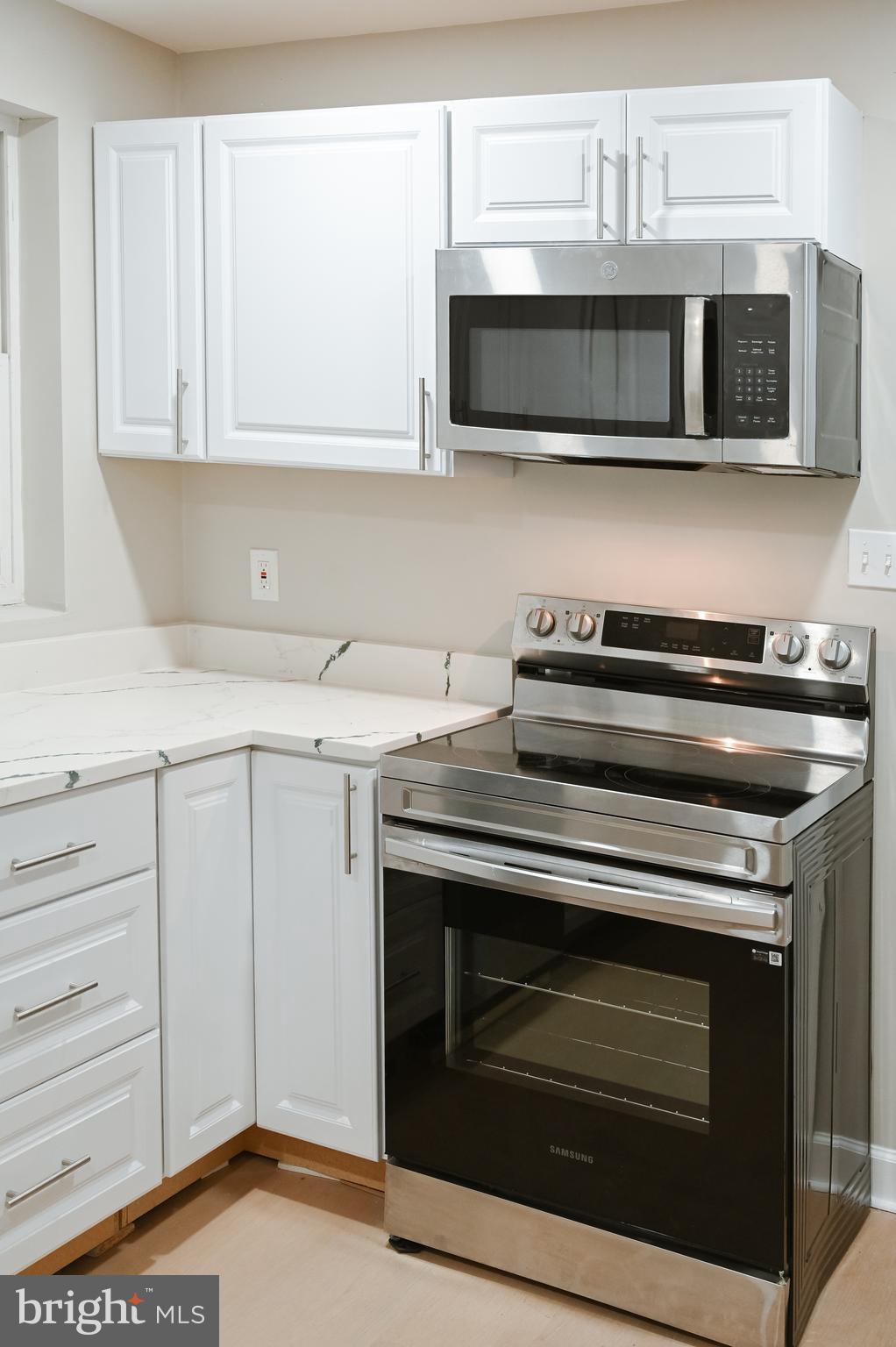 2214 East Fayette Street Baltimore, MD 21231 - Photo 14 of 40 a kitchen with stainless steel appliances granite countertop a stove microwave and sink