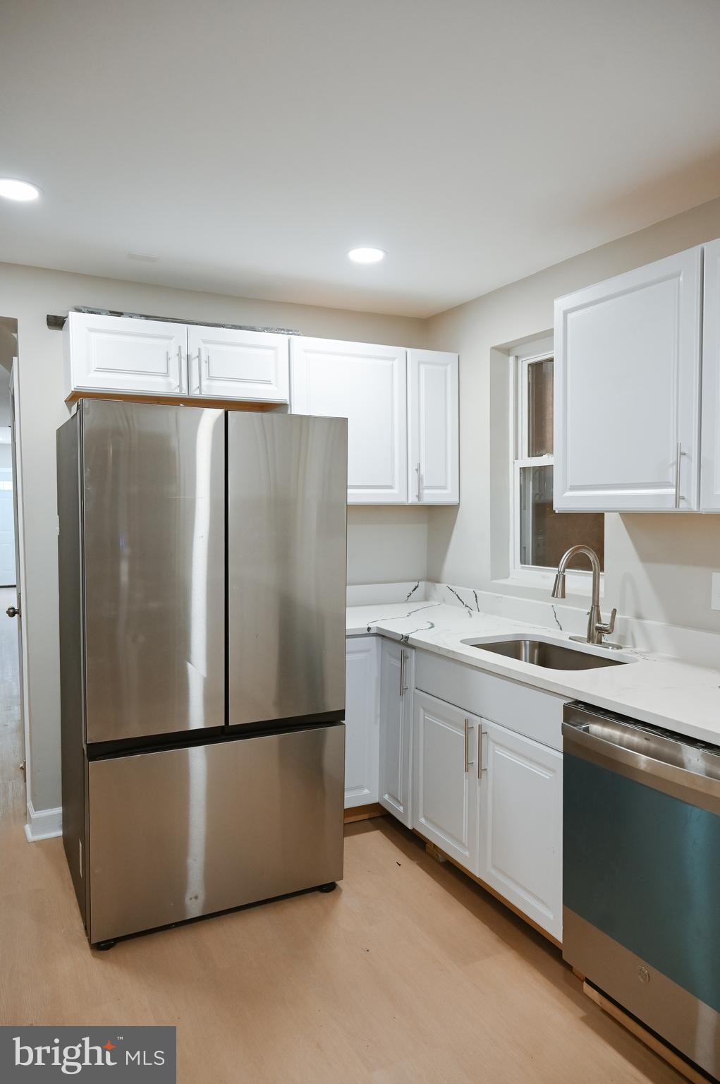 2214 East Fayette Street Baltimore, MD 21231 - Photo 15 of 40 a kitchen with stainless steel appliances granite countertop a refrigerator sink and cabinets