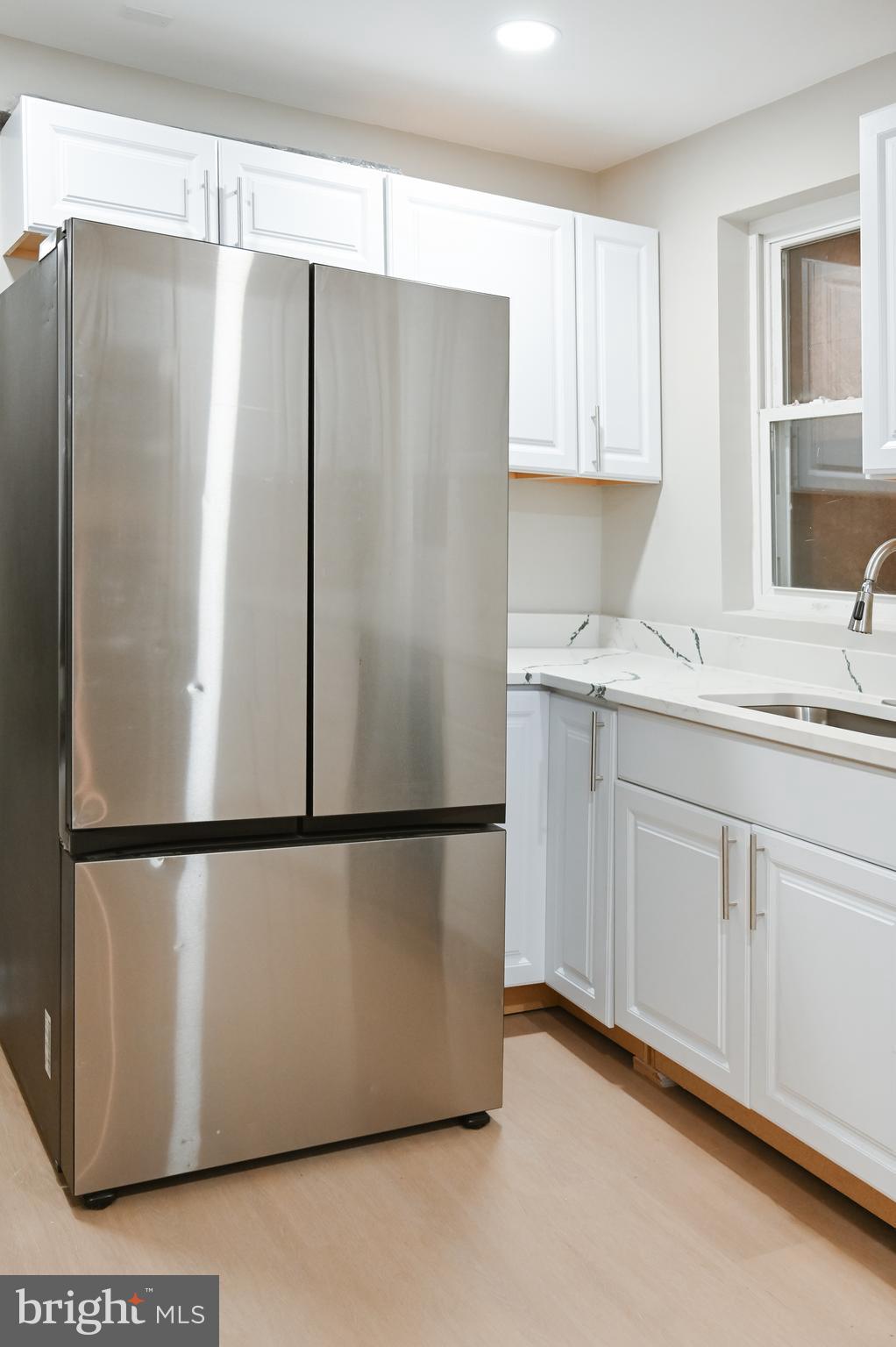 2214 East Fayette Street Baltimore, MD 21231 - Photo 17 of 40 a white refrigerator freezer sitting inside of a kitchen