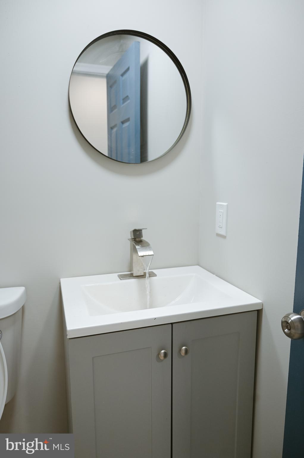 2214 East Fayette Street Baltimore, MD 21231 - Photo 21 of 40 a bathroom with a sink a vanity and a mirror