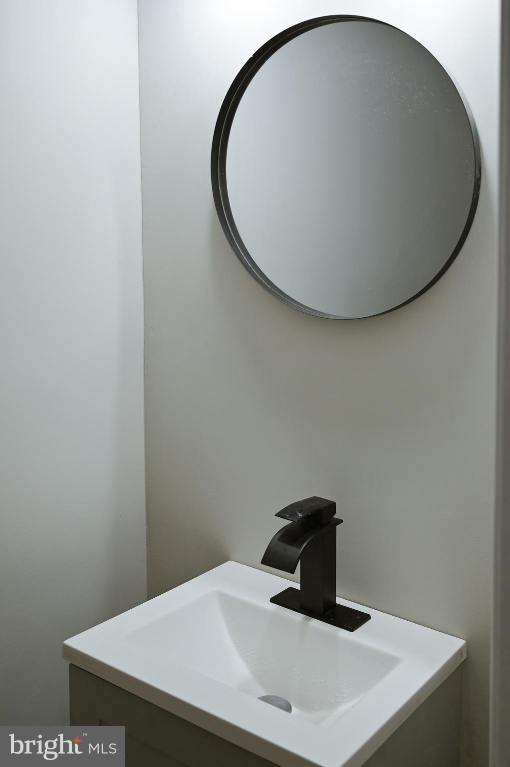 2214 East Fayette Street Baltimore, MD 21231 - Photo 23 of 40 a bathroom with a sink and vanity