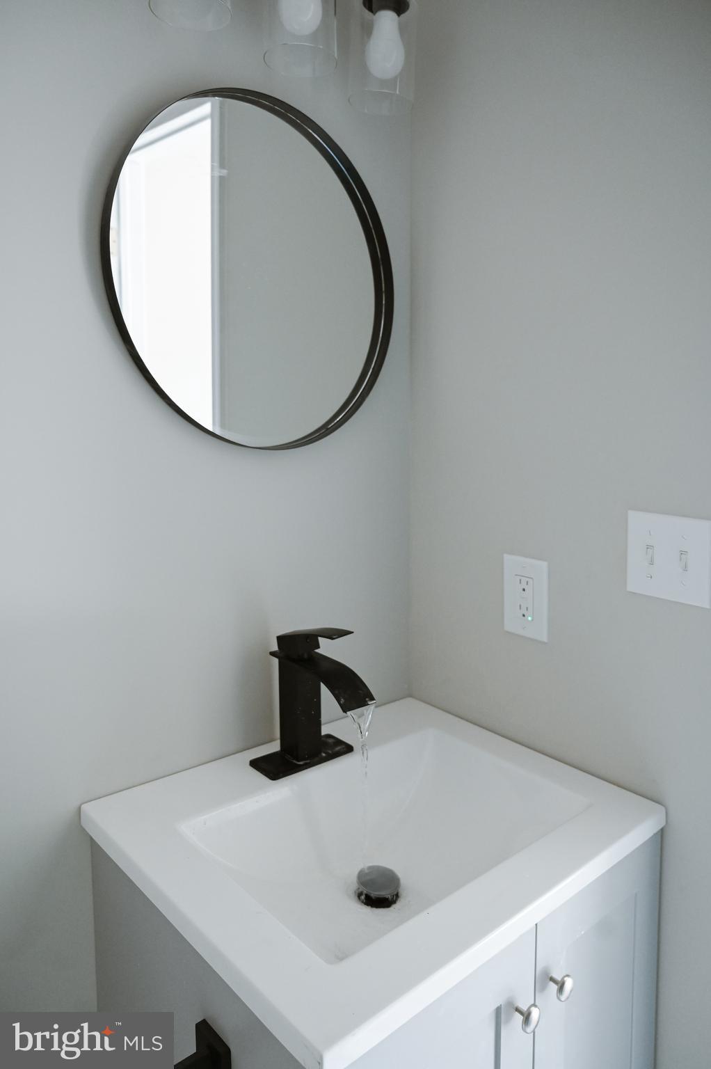 2214 East Fayette Street Baltimore, MD 21231 - Photo 25 of 40 a bathroom with a sink and a mirror