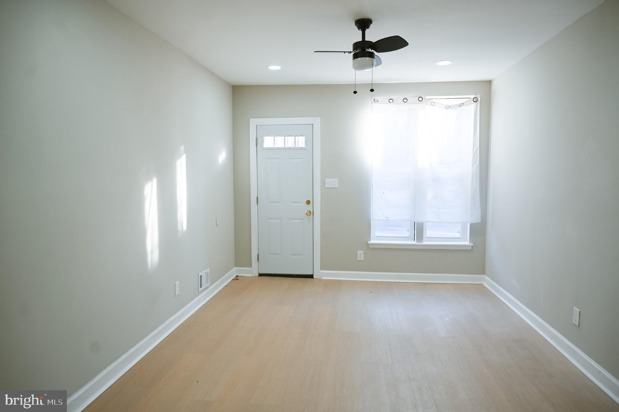 2214 East Fayette Street Baltimore, MD 21231 - Photo 3 of 40 an empty room with windows and cabinet
