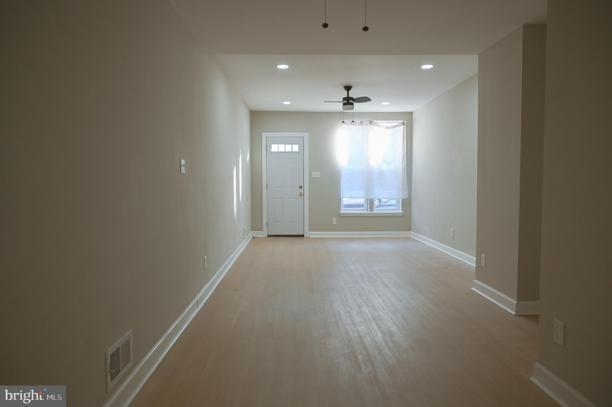 2214 East Fayette Street Baltimore, MD 21231 - Photo 5 of 40 an empty room with windows and entrance