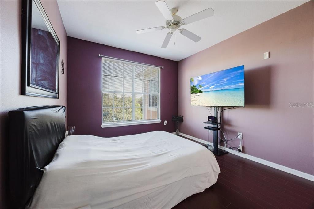 12849 Madison Pointe Circle, Unit 307 Orlando, FL 32821 - Photo 12 of 25 a bedroom with a bed and a chandelier