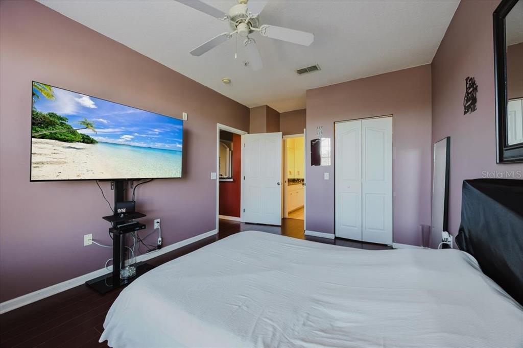 12849 Madison Pointe Circle, Unit 307 Orlando, FL 32821 - Photo 13 of 25 a bedroom with a bed and a flat screen tv