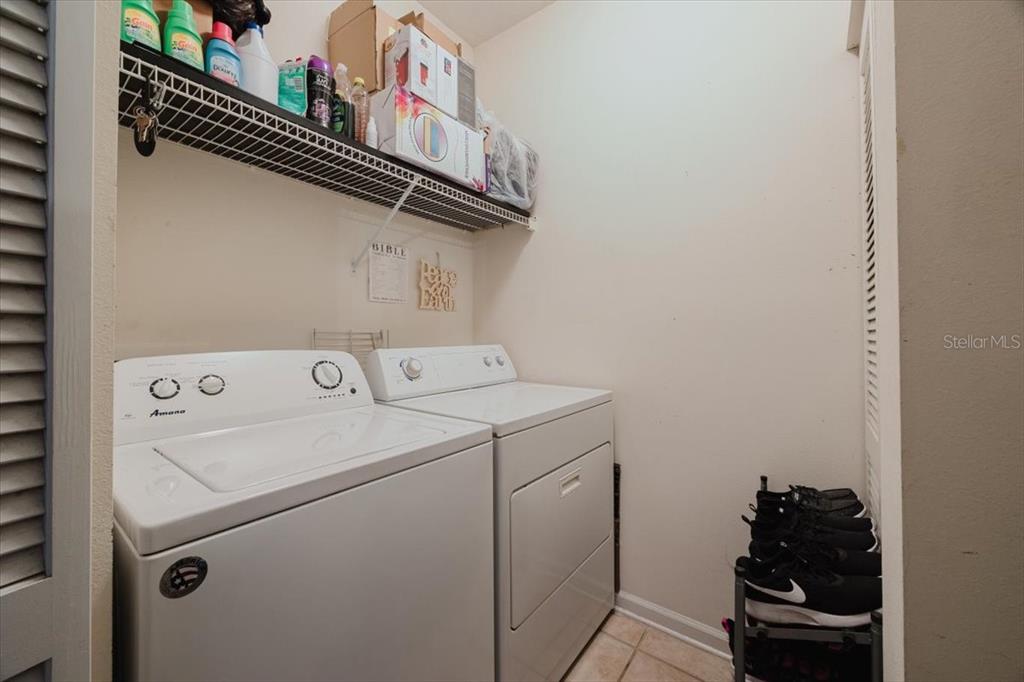 12849 Madison Pointe Circle, Unit 307 Orlando, FL 32821 - Photo 19 of 25 a utility room with dryer and washer