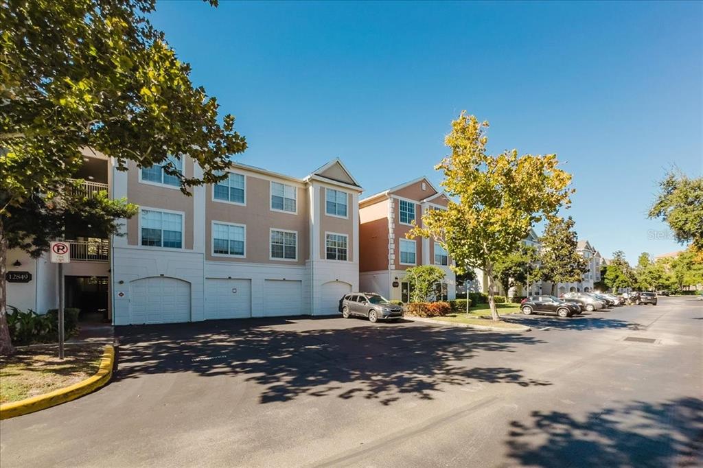 12849 Madison Pointe Circle, Unit 307 Orlando, FL 32821 - Photo 21 of 25 a street sign on a sidewalk next to a road