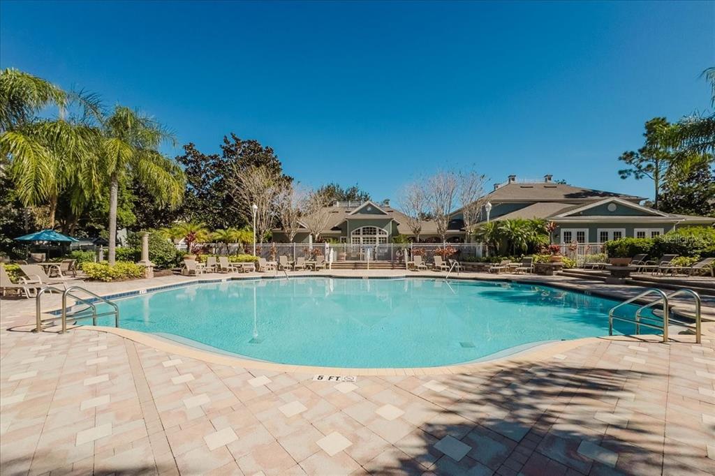 12849 Madison Pointe Circle, Unit 307 Orlando, FL 32821 - Photo 22 of 25 a view of swimming pool with outdoor seating and plants