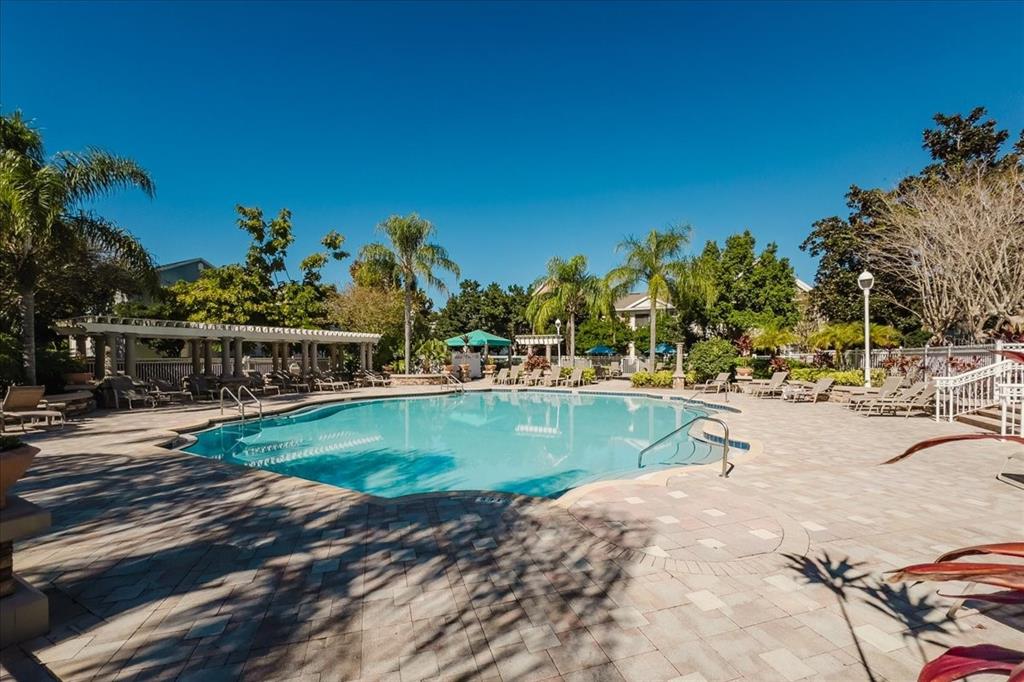 12849 Madison Pointe Circle, Unit 307 Orlando, FL 32821 - Photo 23 of 25 a view of a swimming pool with an outdoor space and seating area