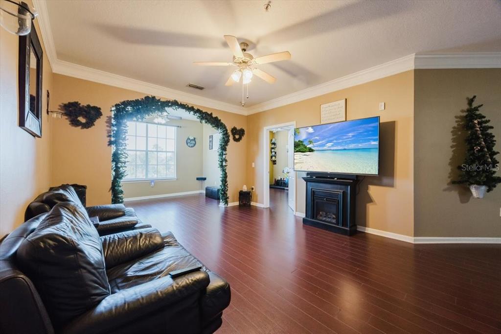 12849 Madison Pointe Circle, Unit 307 Orlando, FL 32821 - Photo 3 of 25 a living room with furniture and a fireplace
