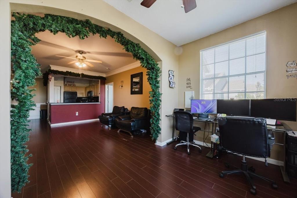 12849 Madison Pointe Circle, Unit 307 Orlando, FL 32821 - Photo 6 of 25 a workspace with wooden floor and windows