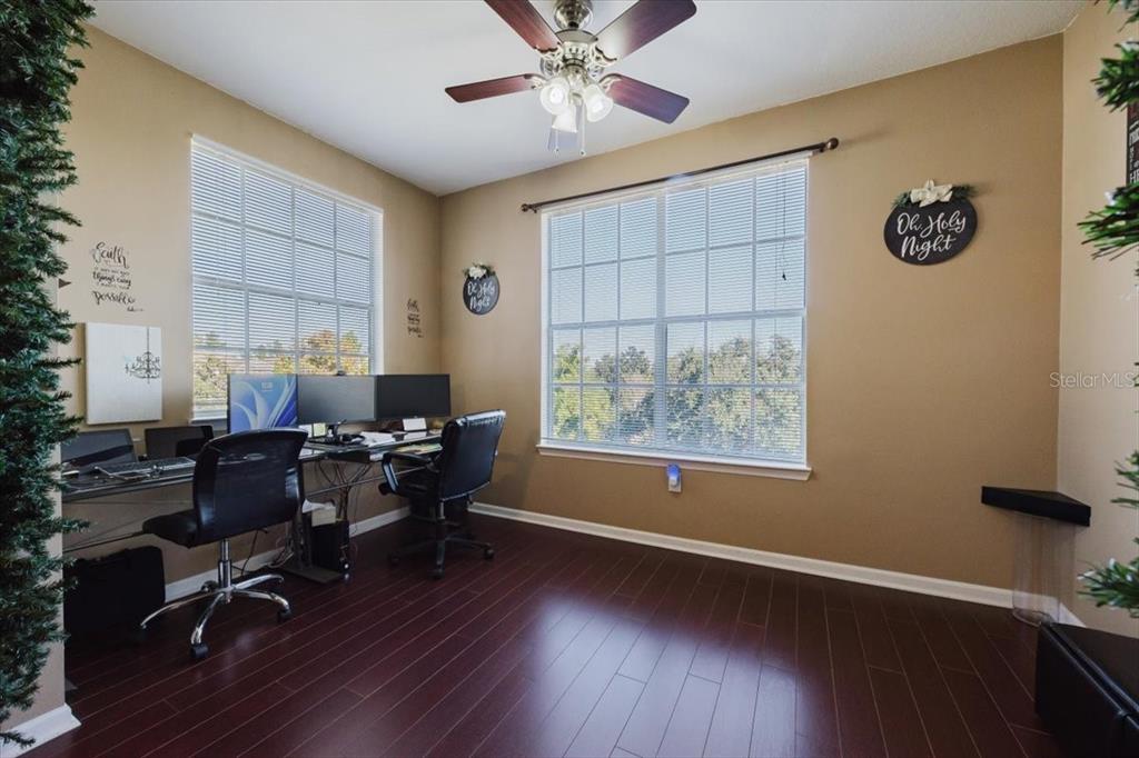 12849 Madison Pointe Circle, Unit 307 Orlando, FL 32821 - Photo 7 of 25 a workspace with wooden floor and a window