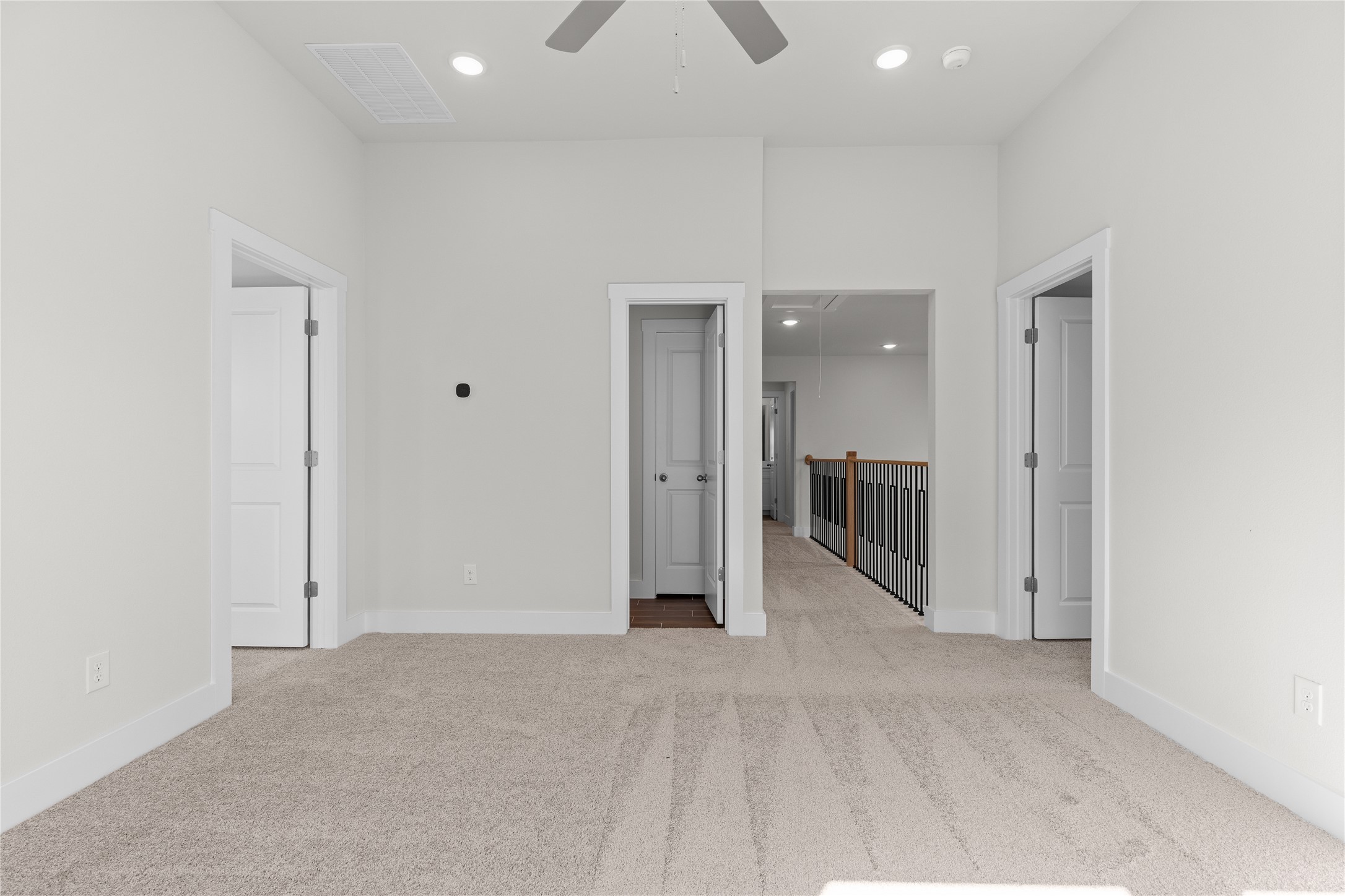19705 Domino Champ Road Pflugerville, TX 78660 - Photo 33 of 38 Plush carpeting and recessed lighting create a comfortable atmosphere in this versatile upper-level space.