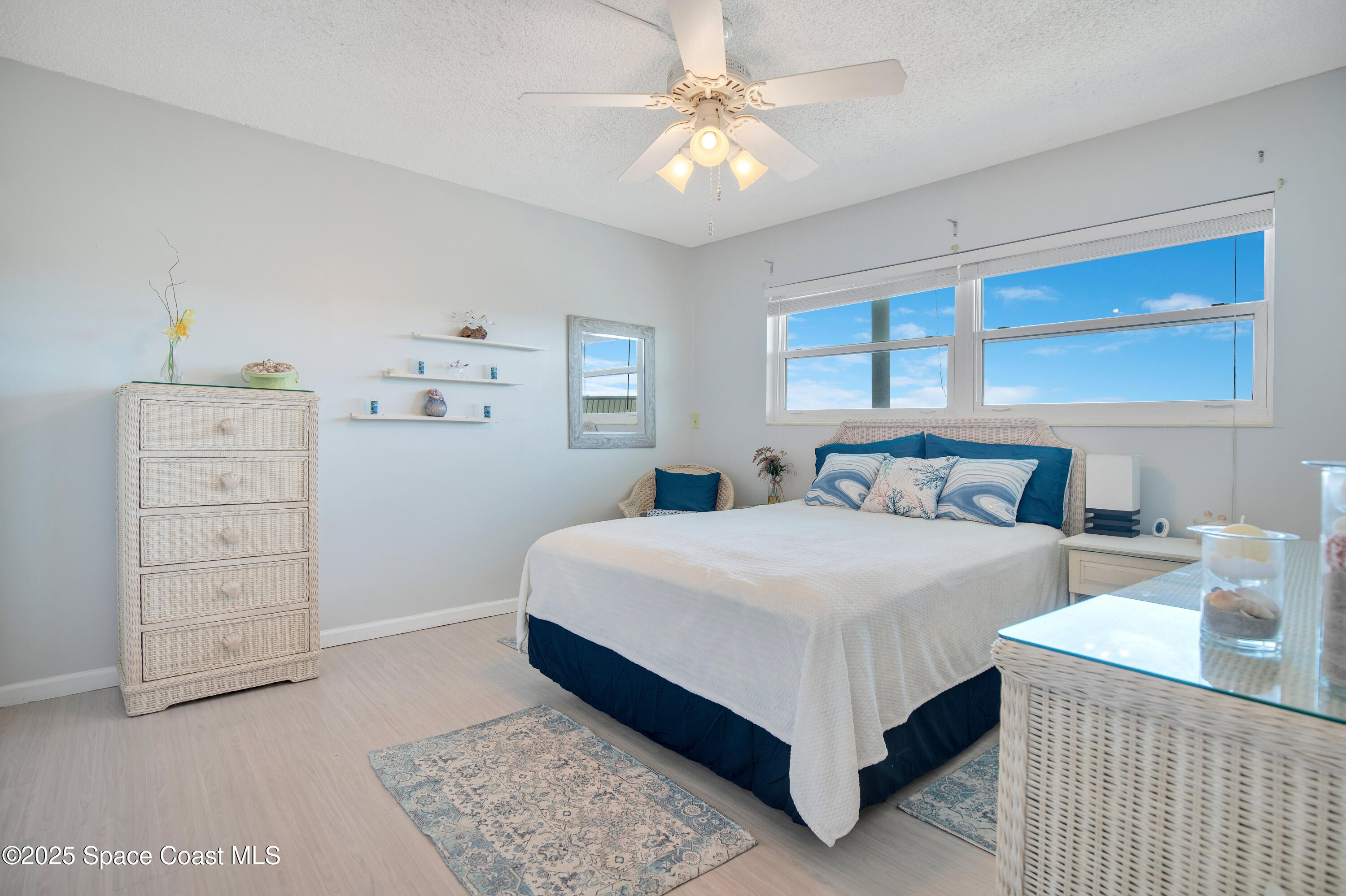 4000 Ocean Beach Boulevard, Unit 5C Cocoa Beach, FL 32931 - Photo 14 of 32 a bedroom with a bed and a chandelier