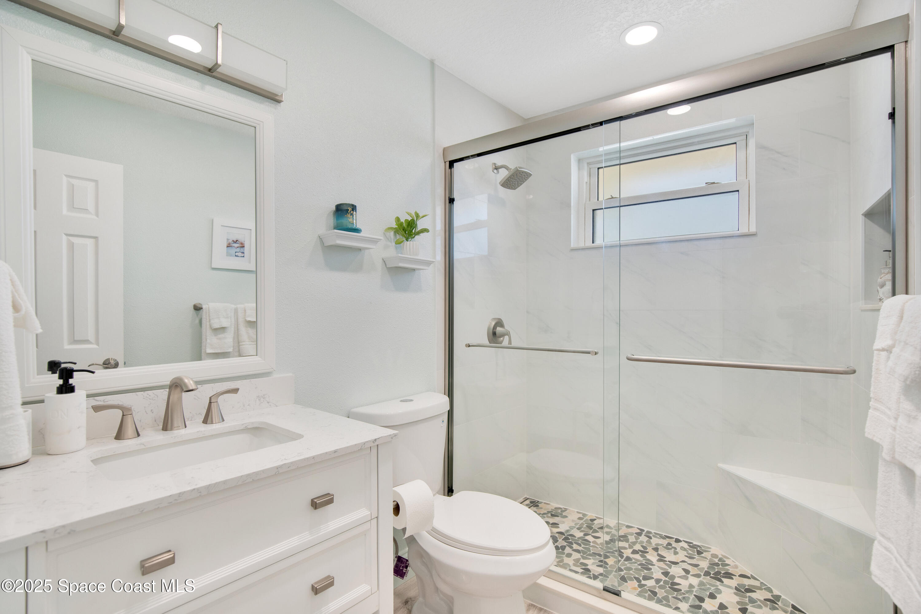 4000 Ocean Beach Boulevard, Unit 5C Cocoa Beach, FL 32931 - Photo 15 of 32 a bathroom with a sink a toilet and shower