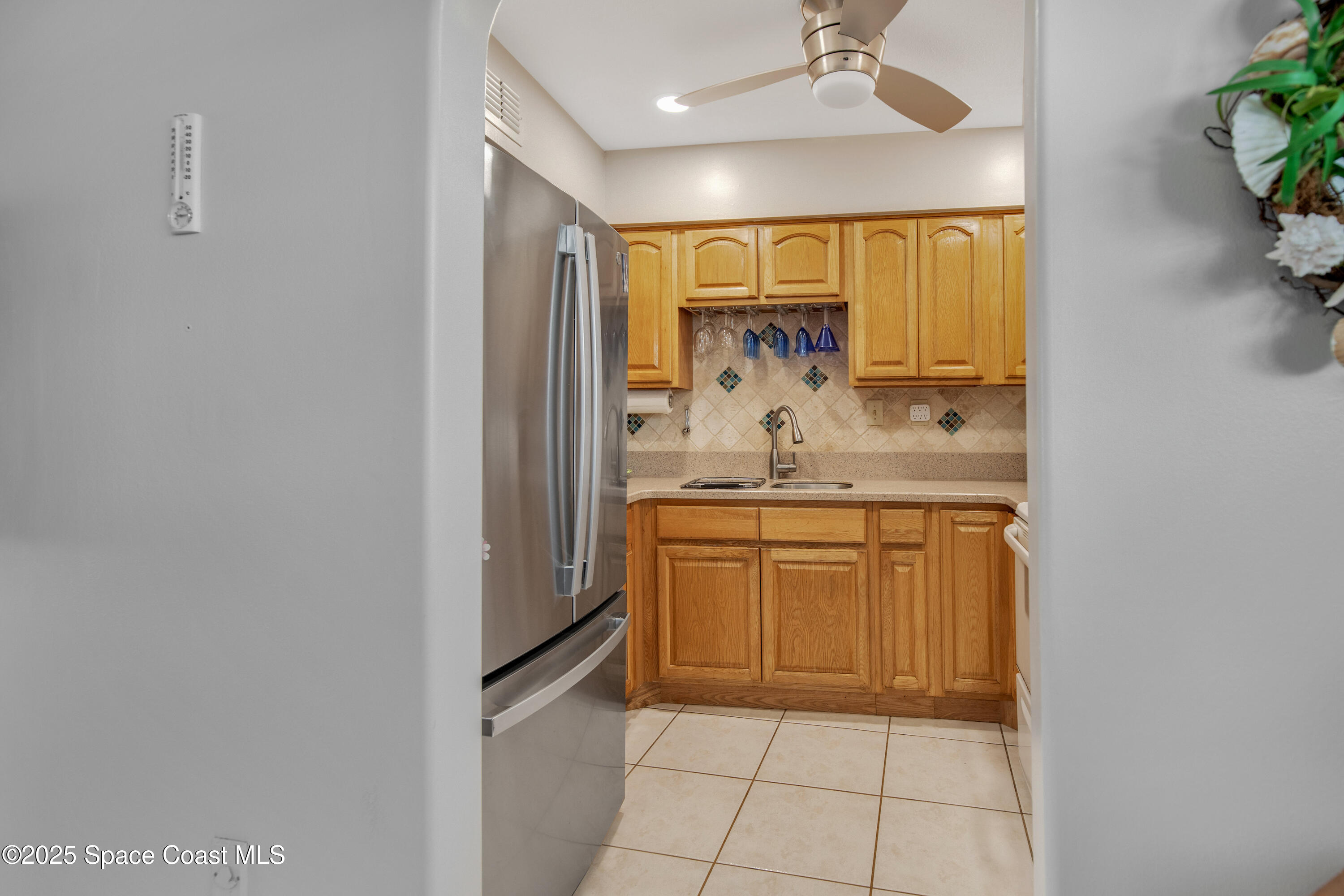 4000 Ocean Beach Boulevard, Unit 5C Cocoa Beach, FL 32931 - Photo 24 of 32 a bathroom with a granite countertop sink and a mirror