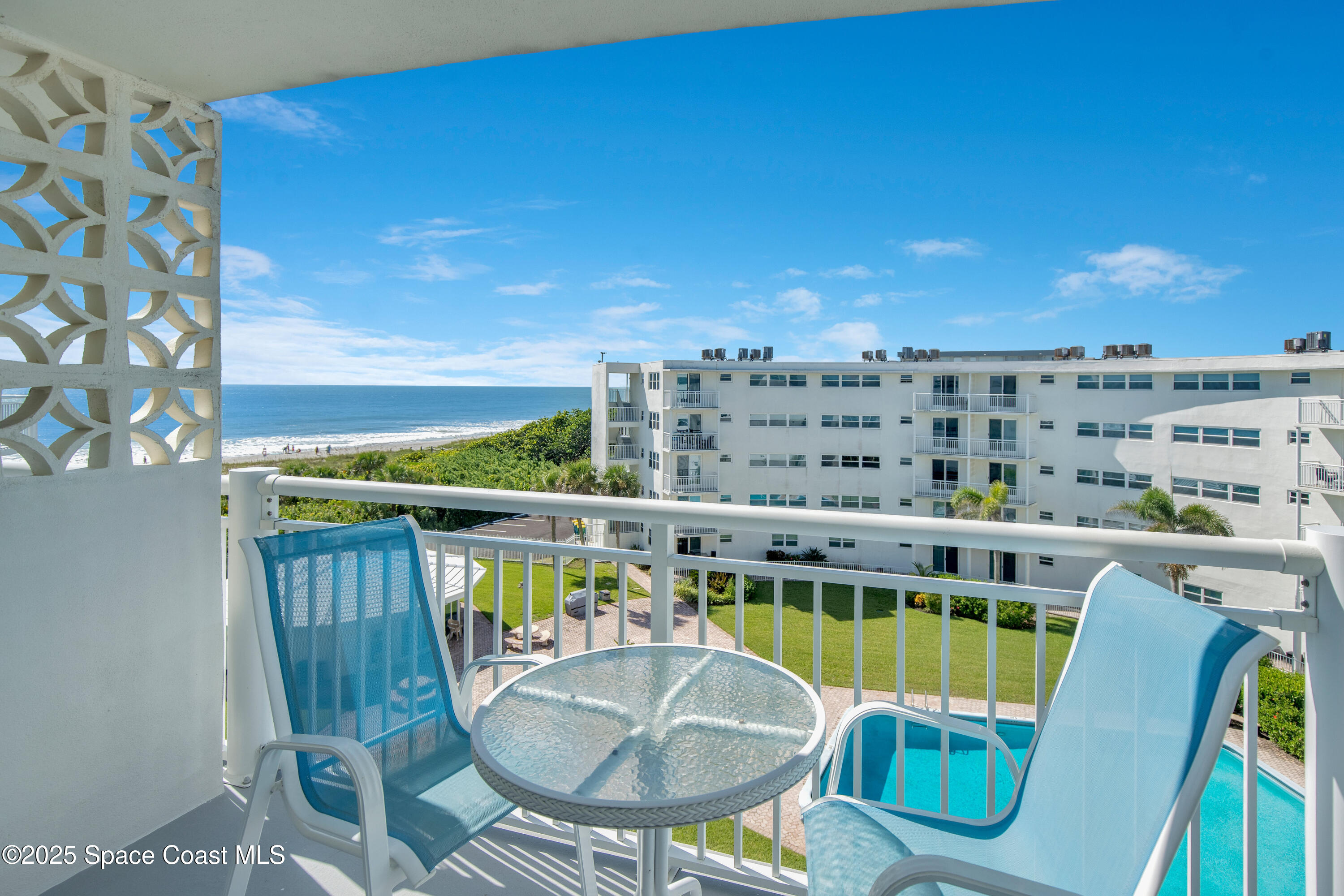 4000 Ocean Beach Boulevard, Unit 5C Cocoa Beach, FL 32931 - Photo 26 of 32 a balcony with table and chairs