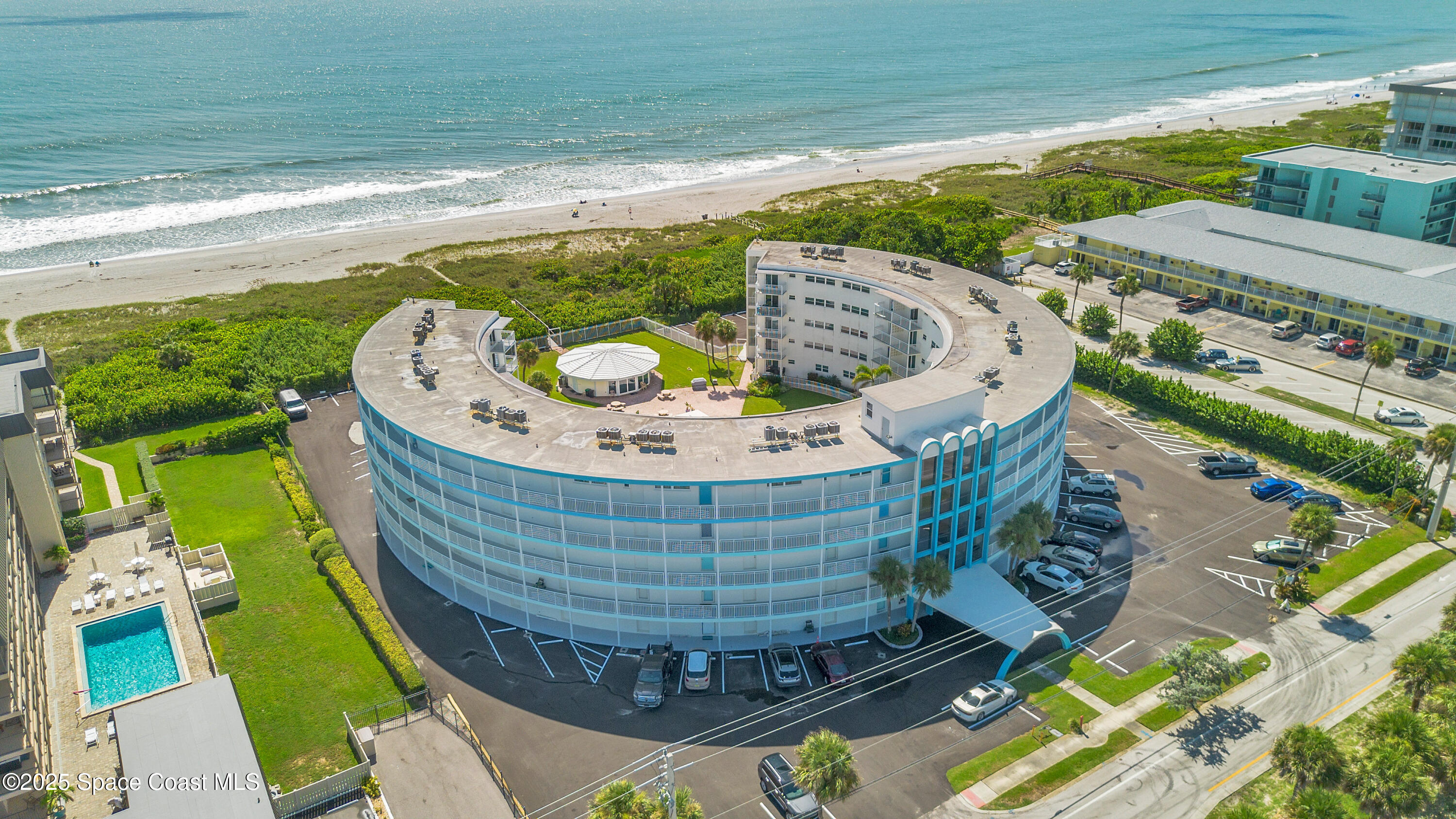 4000 Ocean Beach Boulevard, Unit 5C Cocoa Beach, FL 32931 - Photo 29 of 32 a view of a swimming pool with a garden