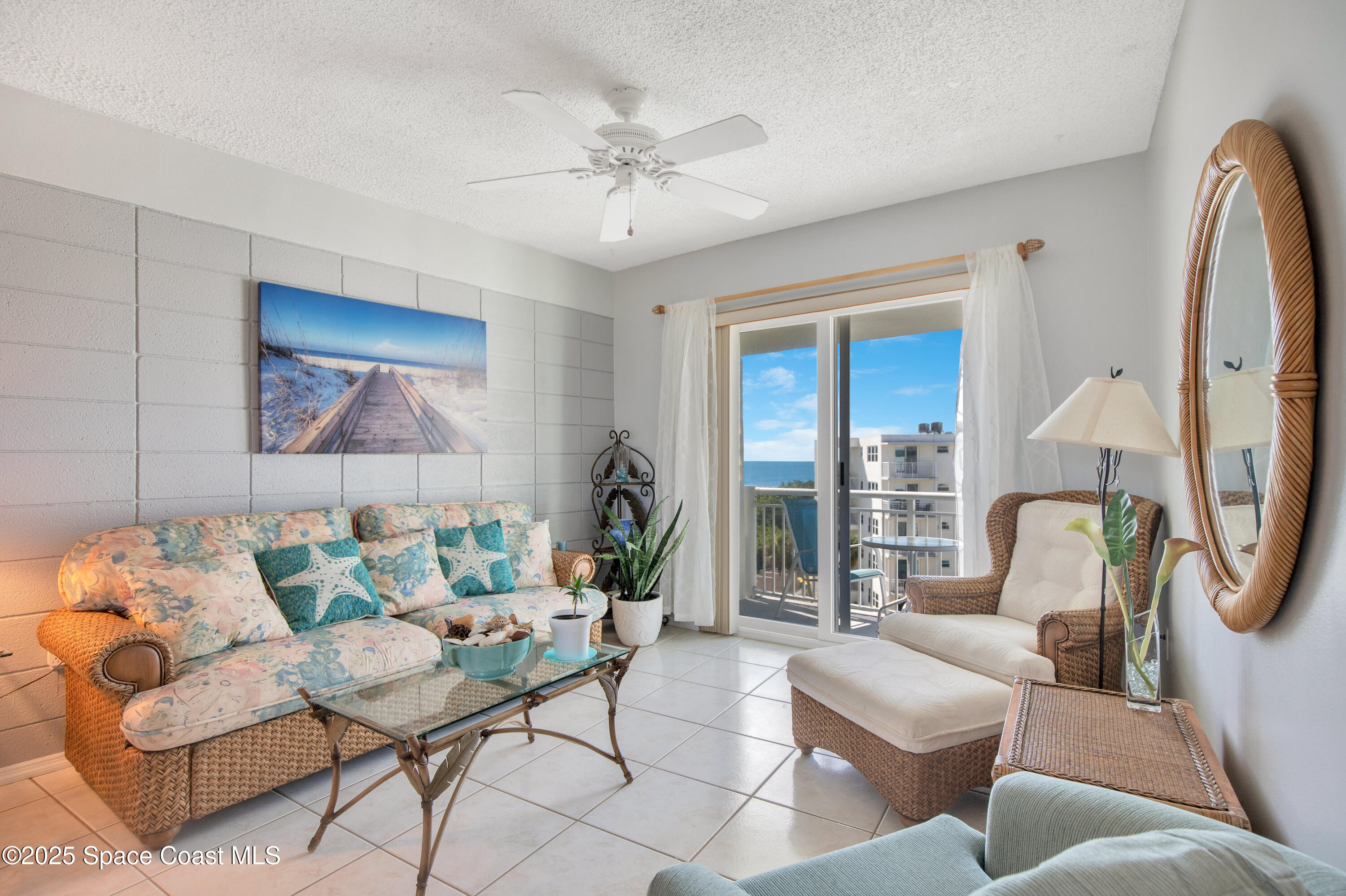 4000 Ocean Beach Boulevard, Unit 5C Cocoa Beach, FL 32931 - Photo 4 of 32 a living room with furniture and a large window