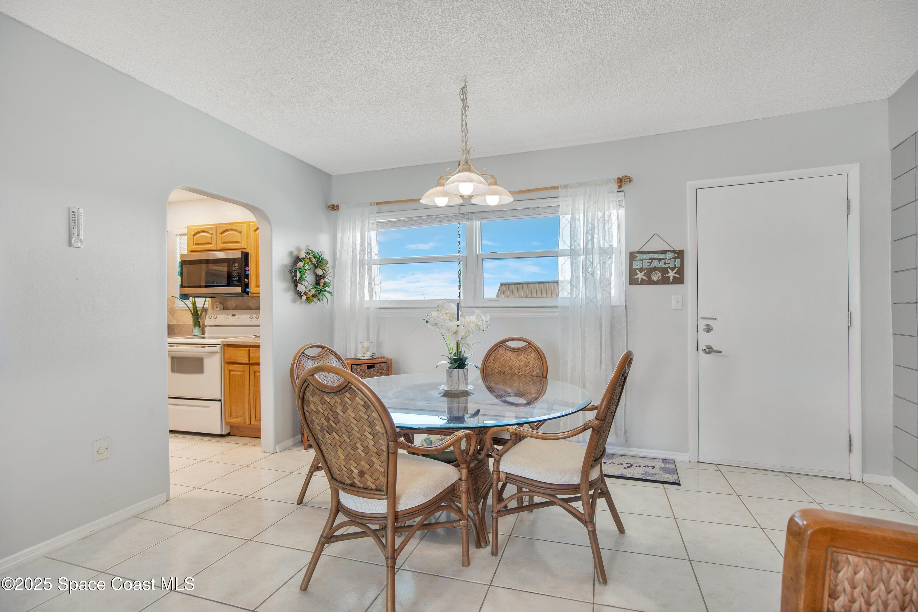 4000 Ocean Beach Boulevard, Unit 5C Cocoa Beach, FL 32931 - Photo 6 of 32 a dining room with furniture and window