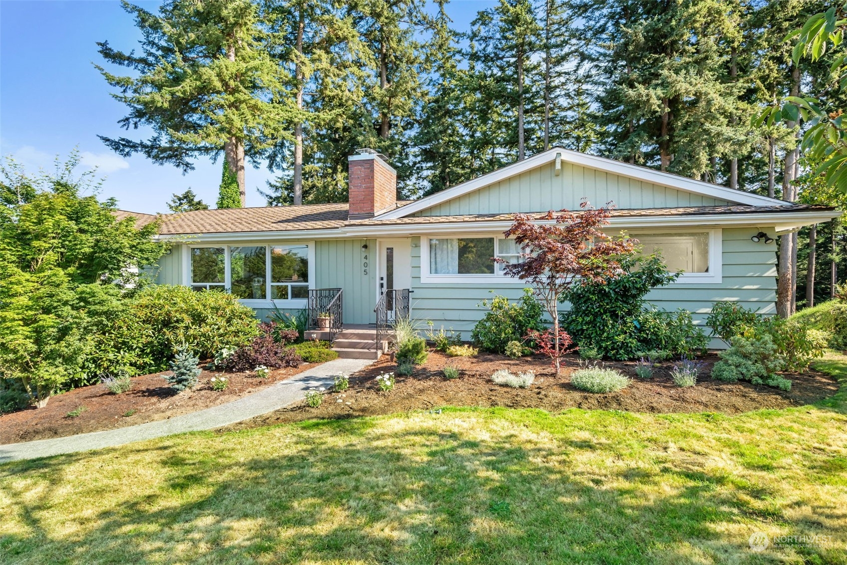 405 Parkridge Road Bellingham, WA 98225 - Photo 1 of 36 a front view of a house with a garden and plants