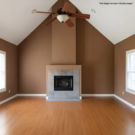 an empty room with windows and fireplace