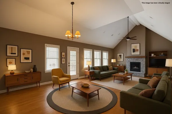 a living room with furniture a fireplace and a chandelier