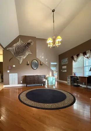 a living room with couch and a chandelier