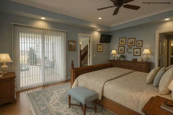 a bedroom with a large bed and a chandelier