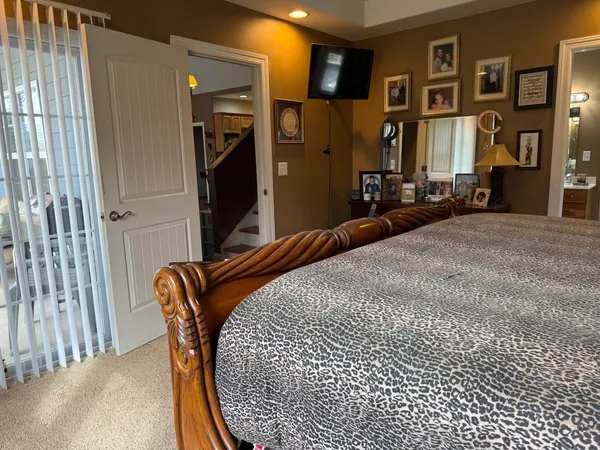 a bedroom with bed and cabinets