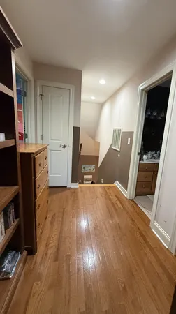 a view of a kitchen with wooden floor and electronic appliances