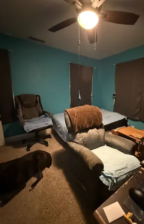 a bedroom with furniture and a chandelier