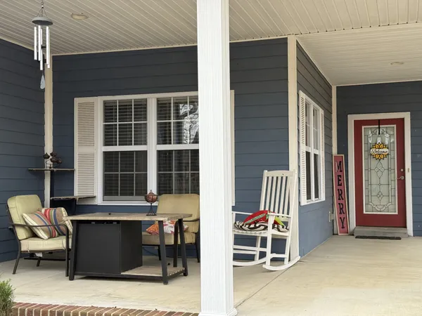 a front view of a house with outdoor seating
