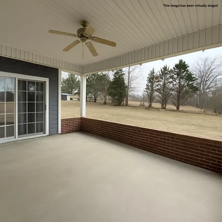 a view of a room with window and a ceiling fan