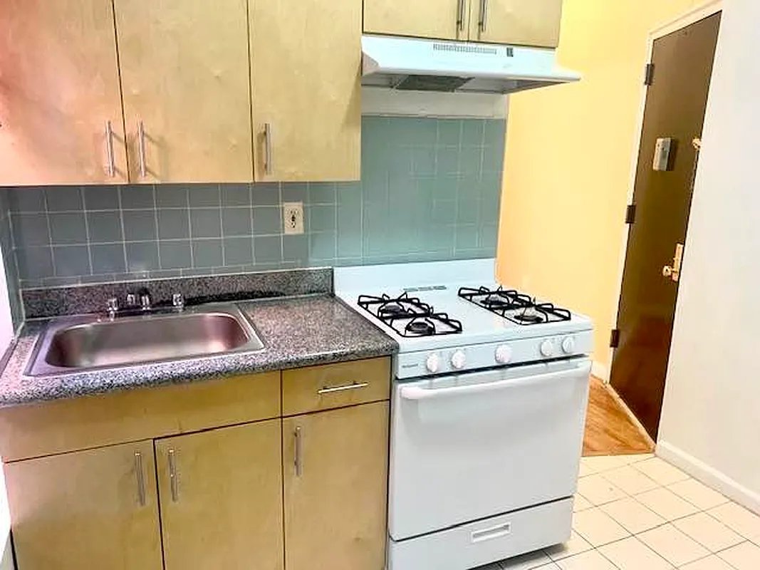 2102 Amsterdam Avenue, Unit 5C Manhattan, NY 10032 - Photo 2 of 5 a kitchen with a sink and a stove top oven