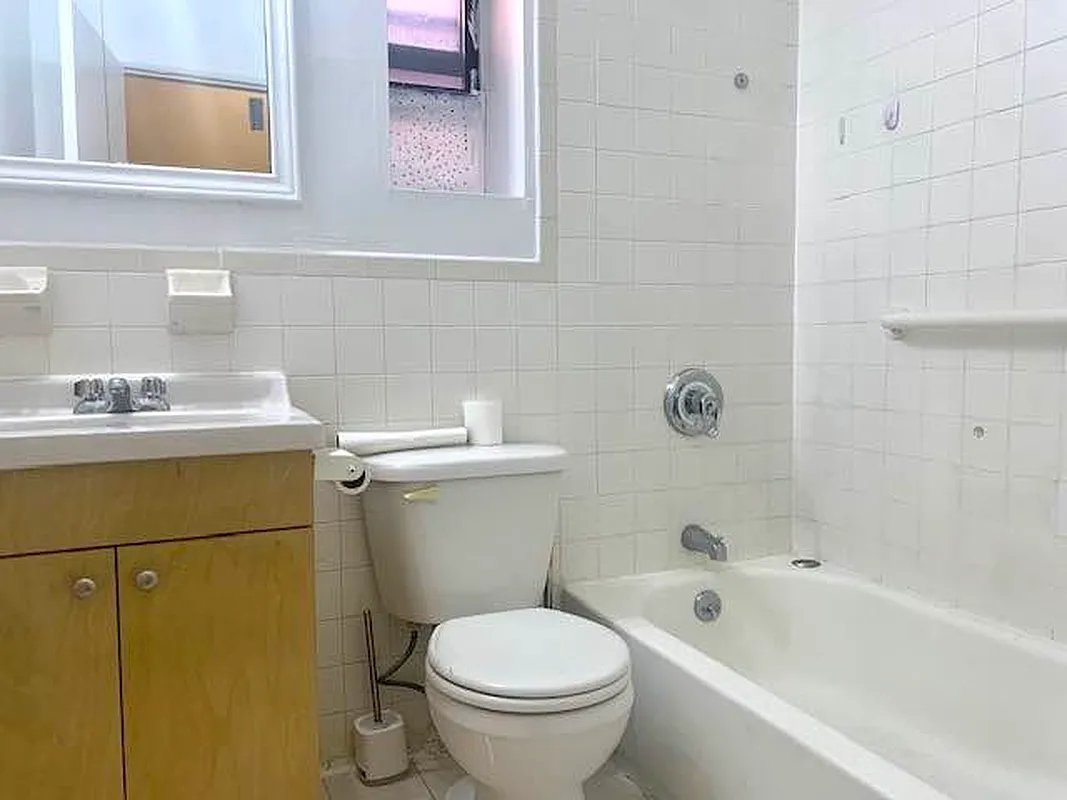 2102 Amsterdam Avenue, Unit 5C Manhattan, NY 10032 - Photo 5 of 5 a bathroom with a sink toilet and bathtub