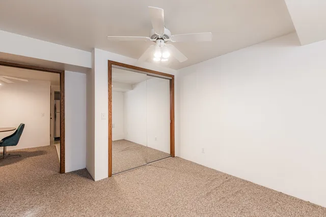 an empty room with fan and entryway