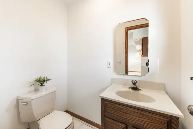 a bathroom with a sink toilet and a mirror